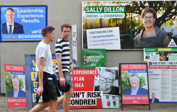 Young men walk past a polling station.