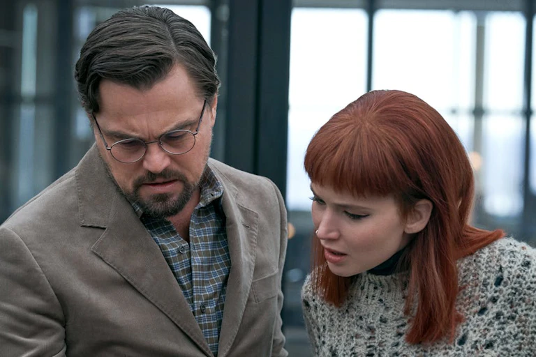 Two people looking at a phone.