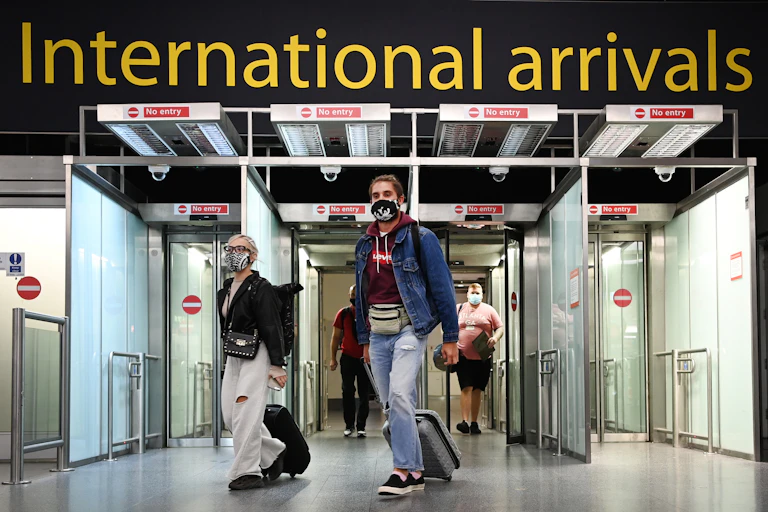 People entering arrivals at an airport