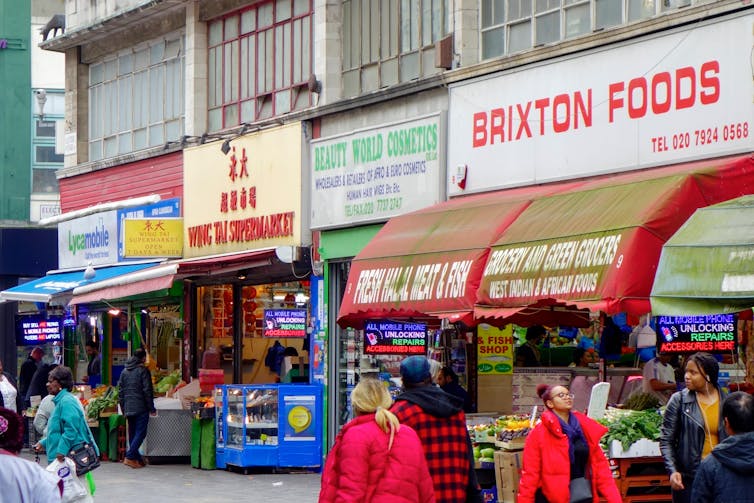 A side view of shopfronts on a market street.