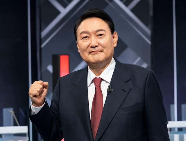 South Korea's president raising his fist.