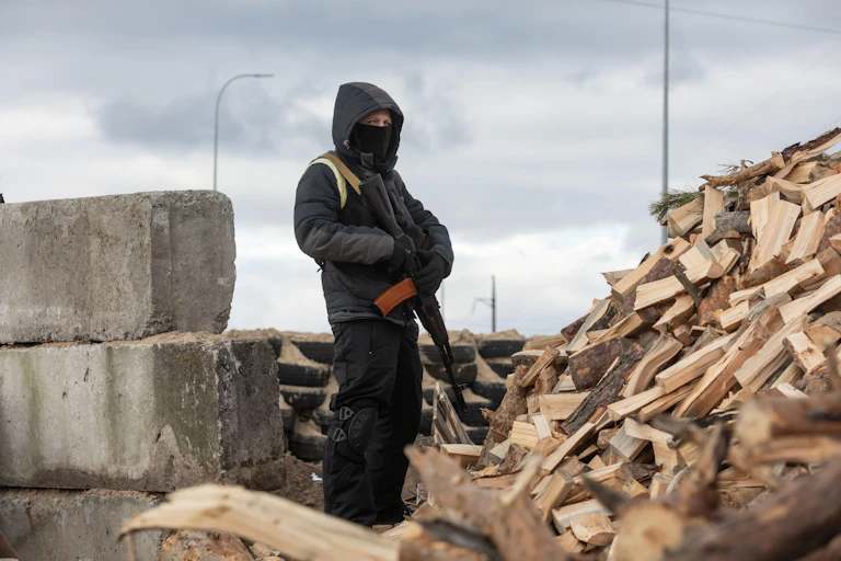 Armed guard at Kyiv checkpoint.
