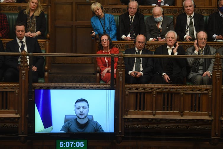 People sitting in the gallery of the House of Commons watching Ukrainian president, Vlodymyr Zelensky, give an address by videolink from Kyiv.