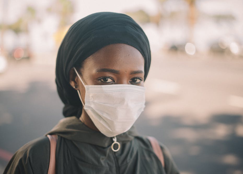 A young person in a face mask wearing a hijab.