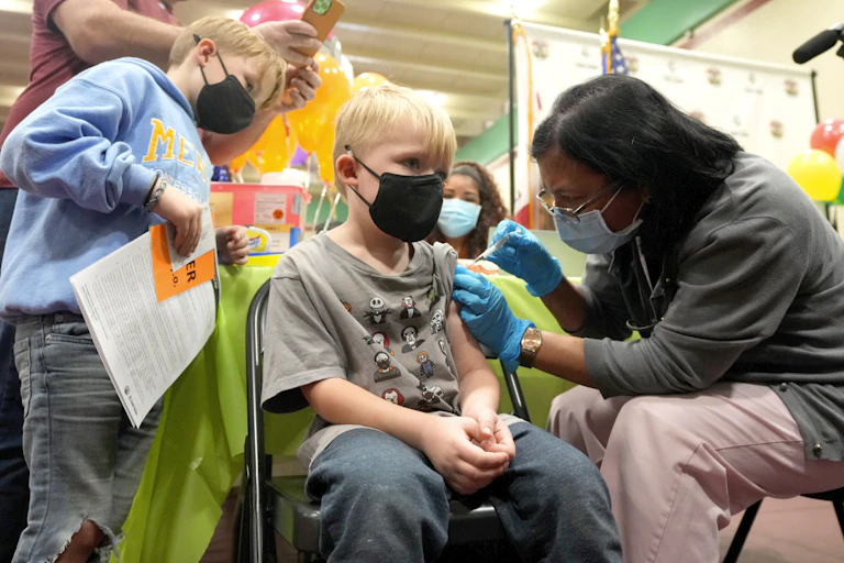 A 5-year-old boy in Los Angeles receives a COVID-19 shot.