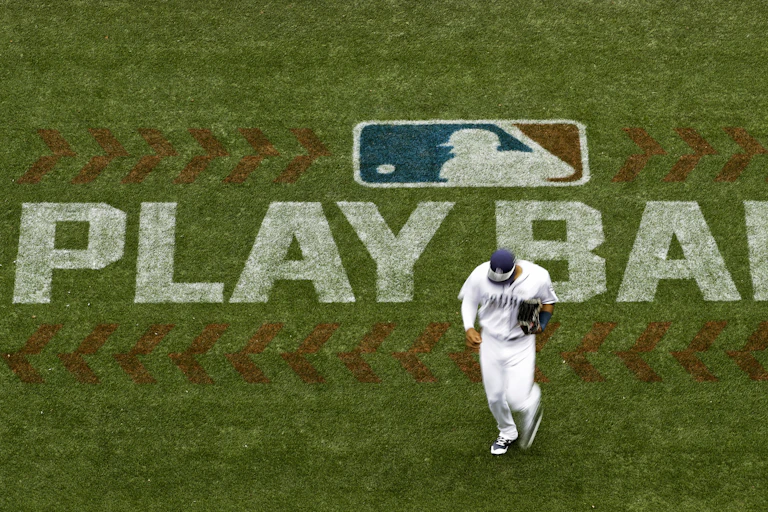 Baseball player runs across field.