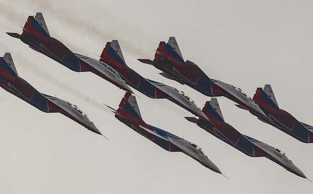 Fighter jet aircraft diving in formation.