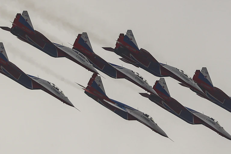 Fighter jet aircraft diving in formation.
