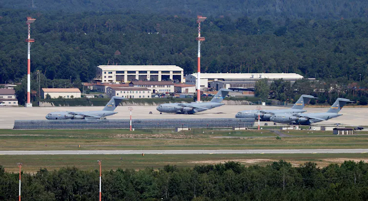 Military aircraft on aiport runway.
