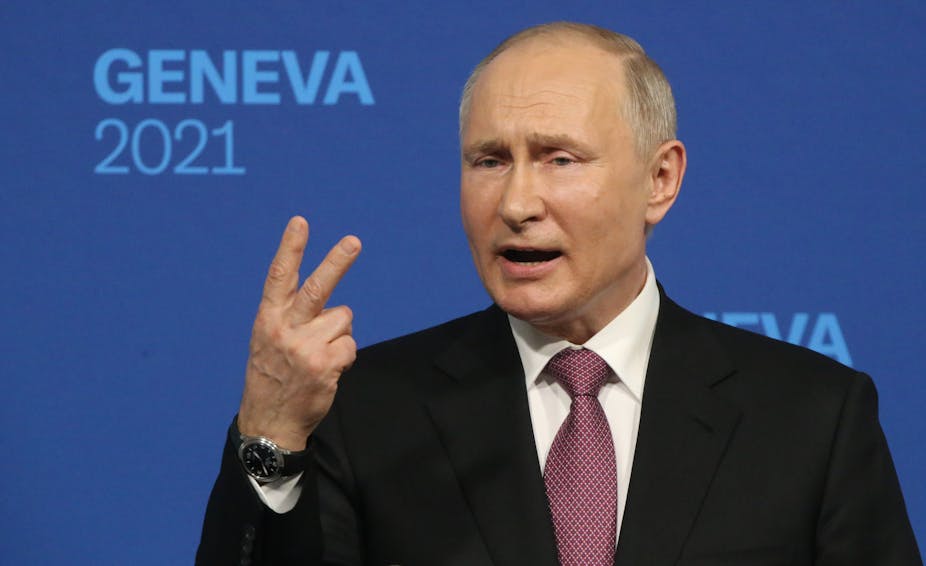President Vladimir Putin uses a v-shape hand gesture.