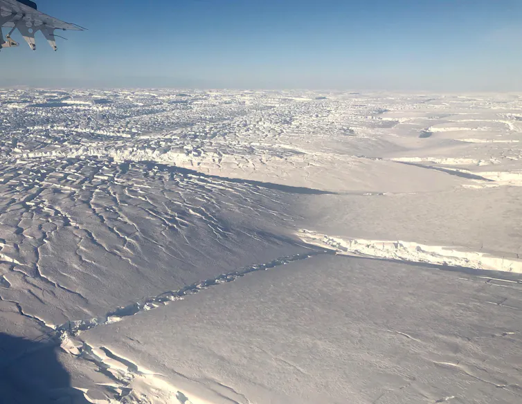 A view across the ice from an airplane showing many fractures.