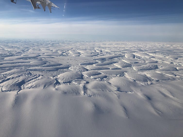 A view across the ice from an airplane showing many fractures.
