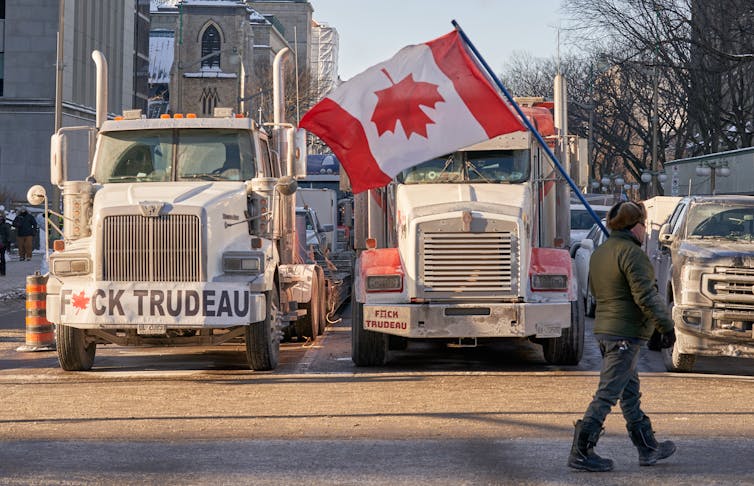 Two trucks bearing slogans against the Canadian prime minister Justin Trudeau