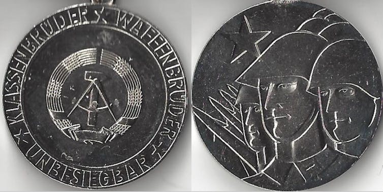 Both sides of a merit medal.