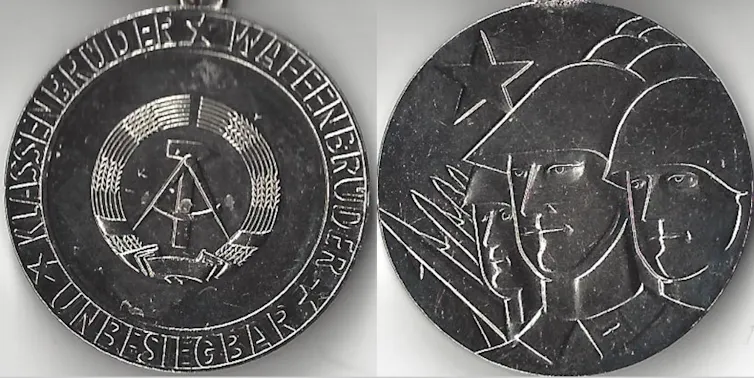 Both sides of a merit medal.