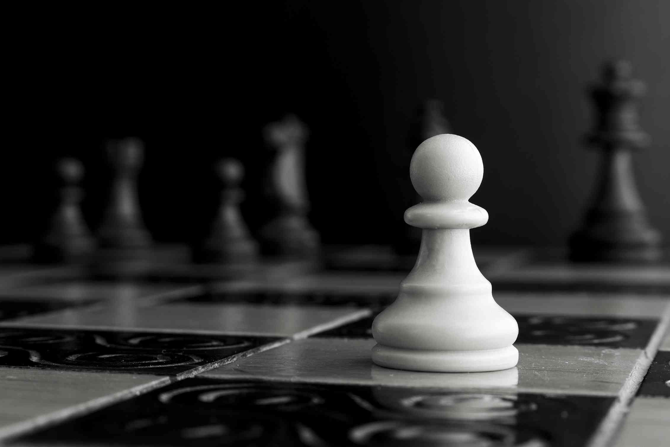 A white pawn on a chessboard.
