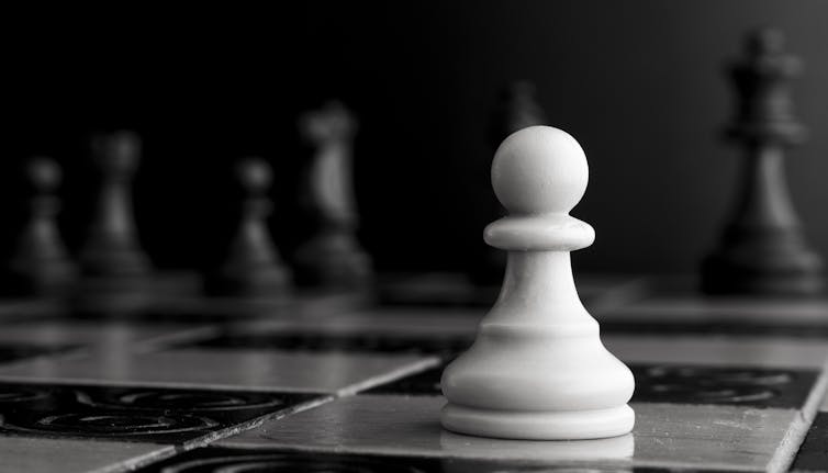 A white pawn on a chessboard.