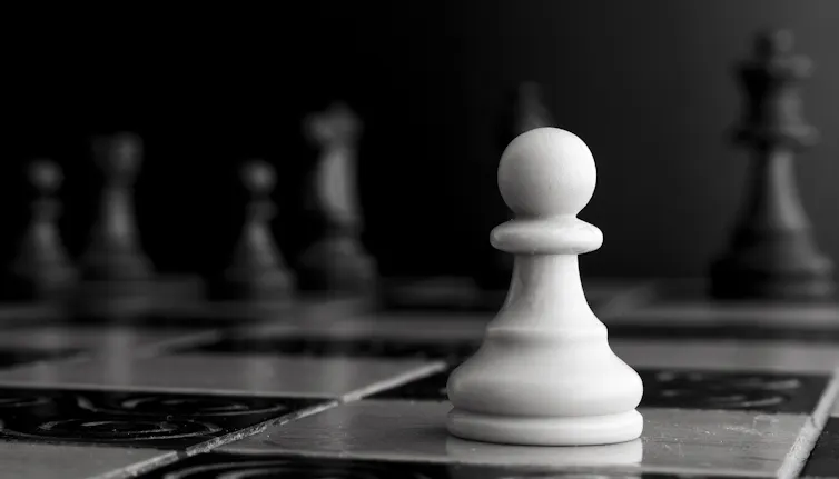 A white pawn on a chessboard.