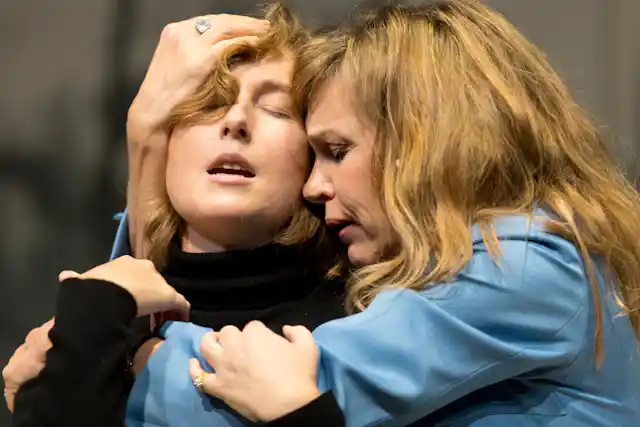 Two women in a claustrophobic embrace