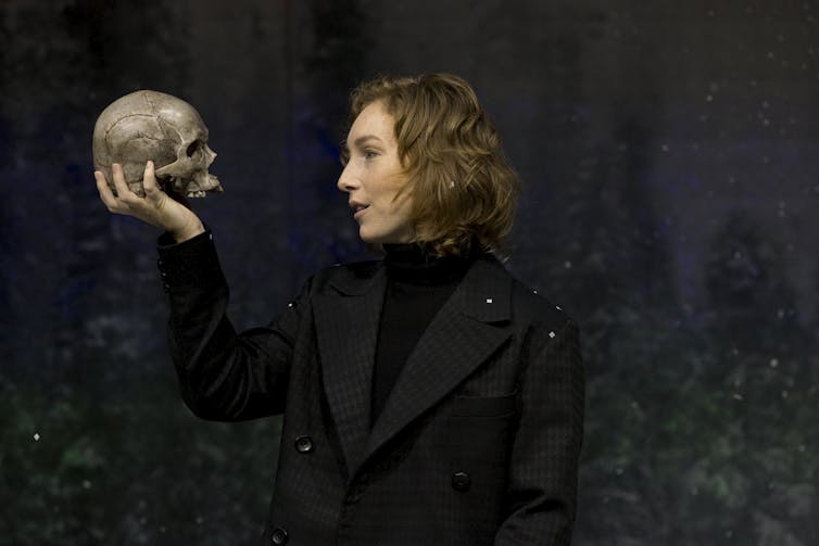 A woman holding a skull.