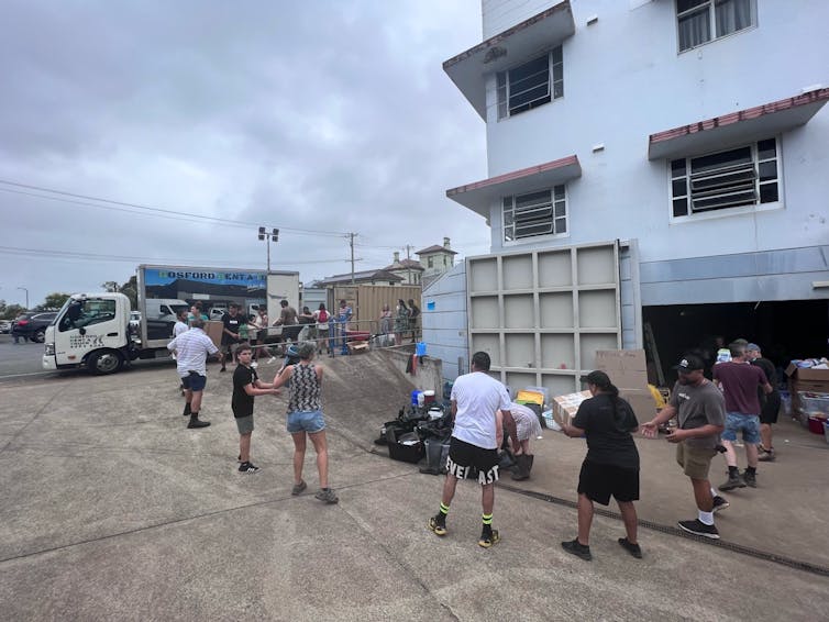 Volunteers help load supplies onto a truck to be delivered to people affected by NSW floods.
