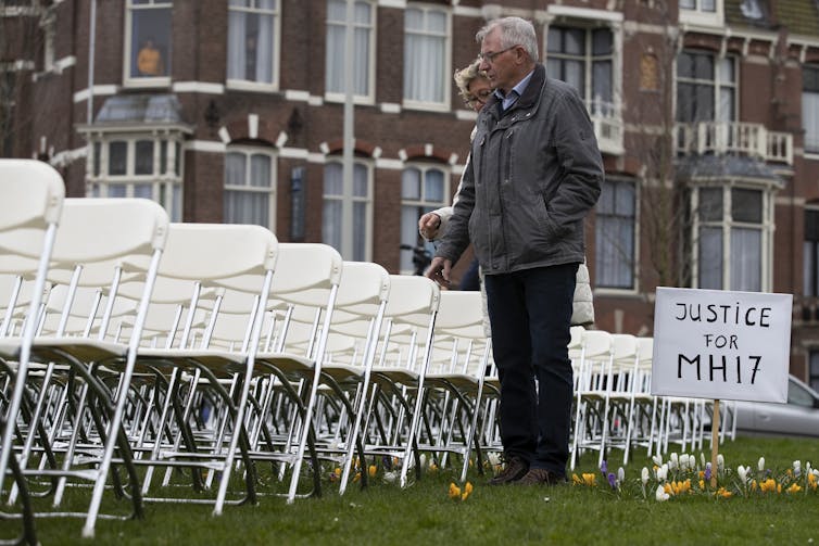 Relatives of flight MH17 victims walking past memorial in the Netherlands.