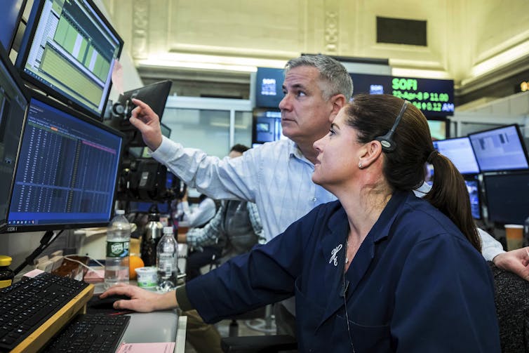 man and woman look at computer screen with concern