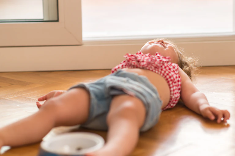young girl having tantrum on floor