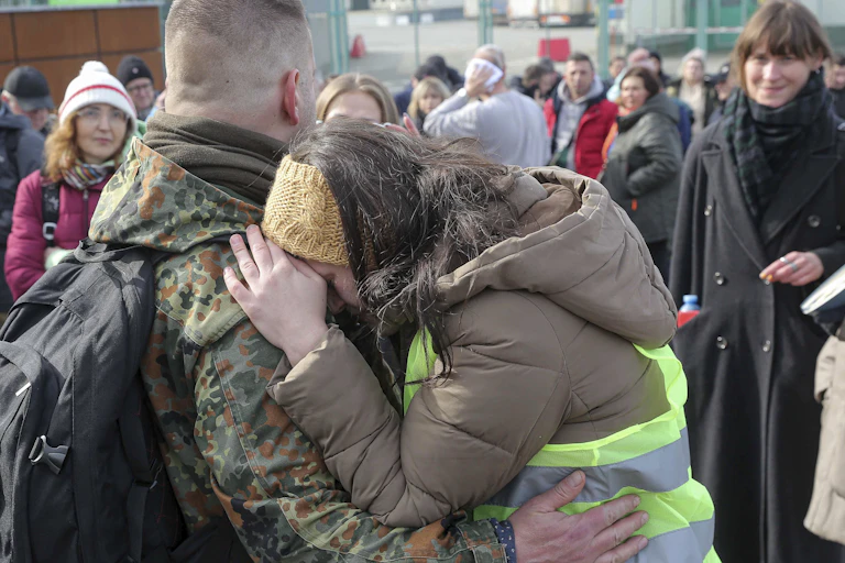 Woman rests her head on shoulder of man.