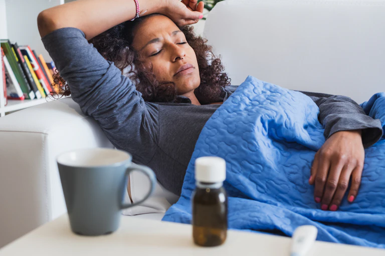 Sick woman lying on sofa