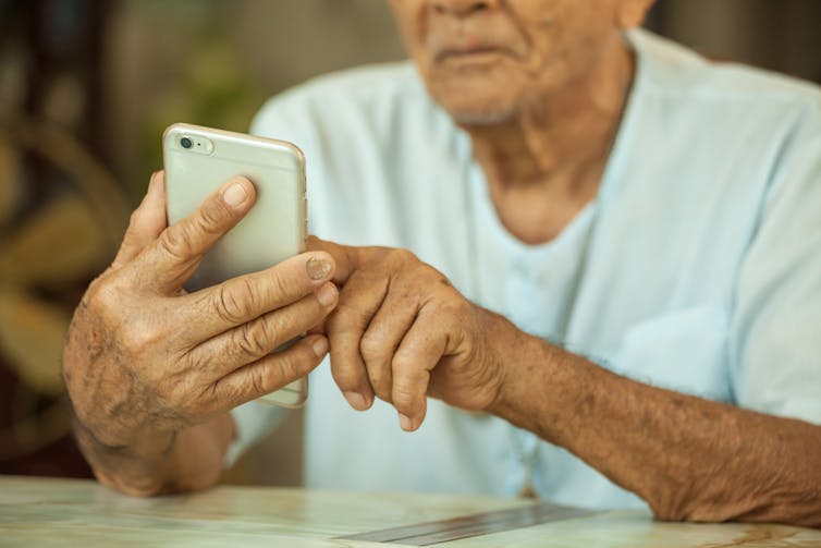 A pensioner using a smartphone