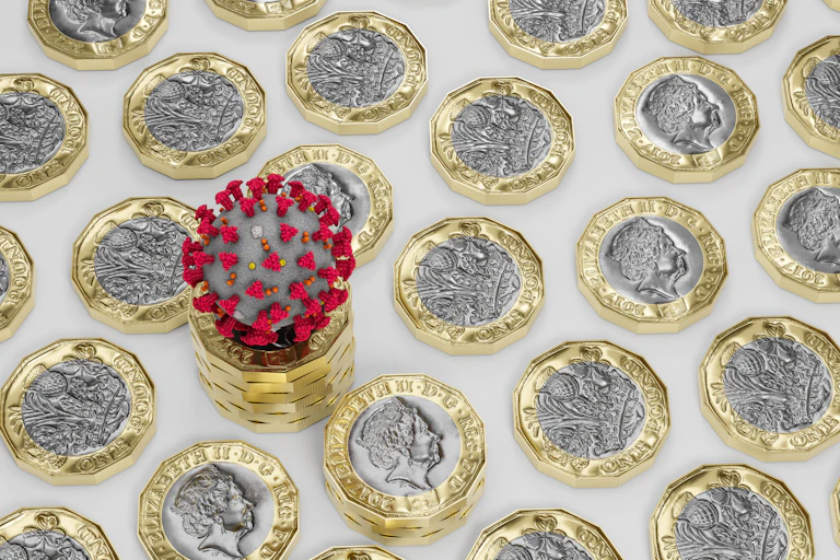 A COVID 'molecule' surrounded by pound coins.