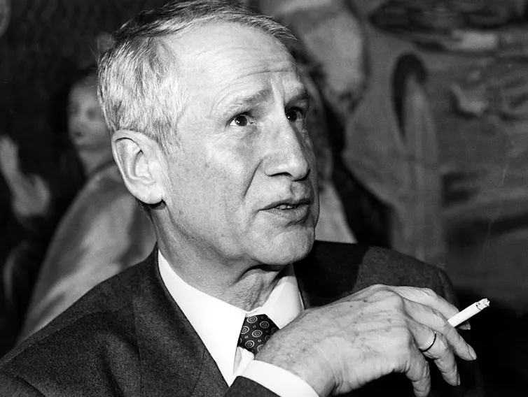 Image of a man holding a cigarette.