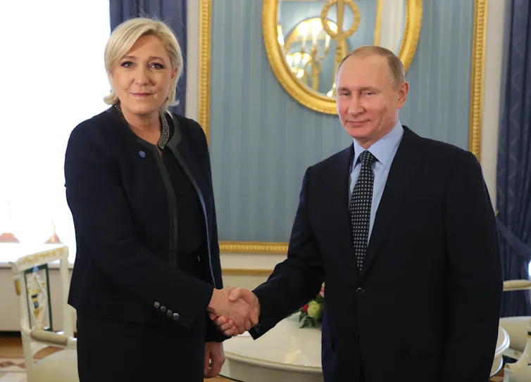 Frnech far-right presidential candidate Marine Le Pen shakes hands with Vladimir Putin in the Kremlin, 2017.