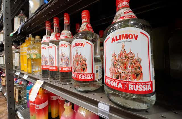 Russian-made vodka with an image of a Russian cathedral line a shelf in a store