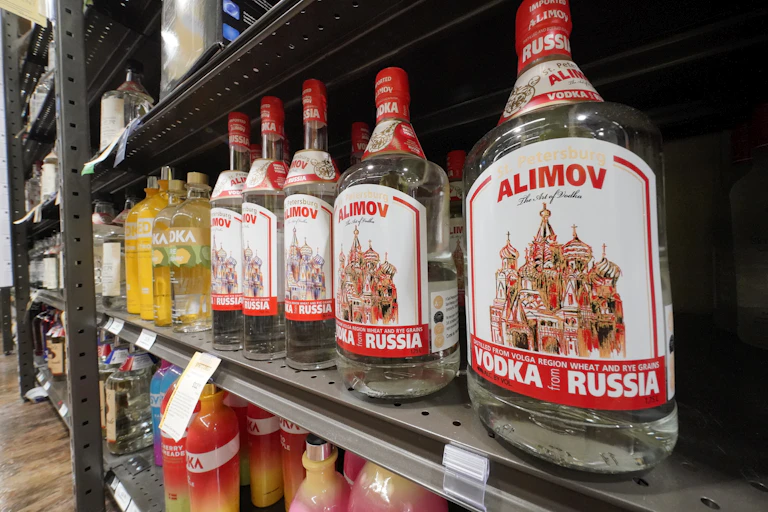 Russian-made vodka with an image of a Russian cathedral line a shelf in a store