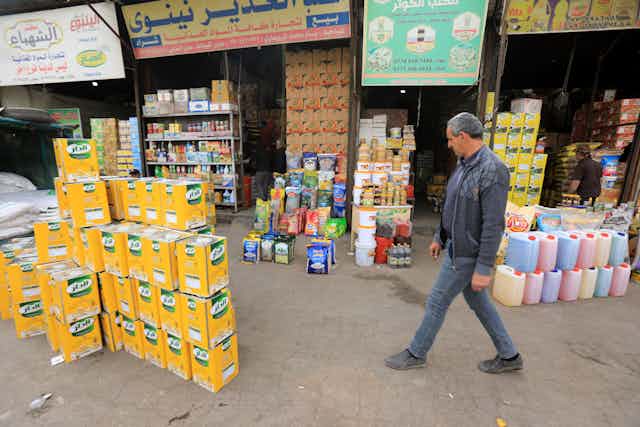 Customer walking through outdoor food market in Baghdad