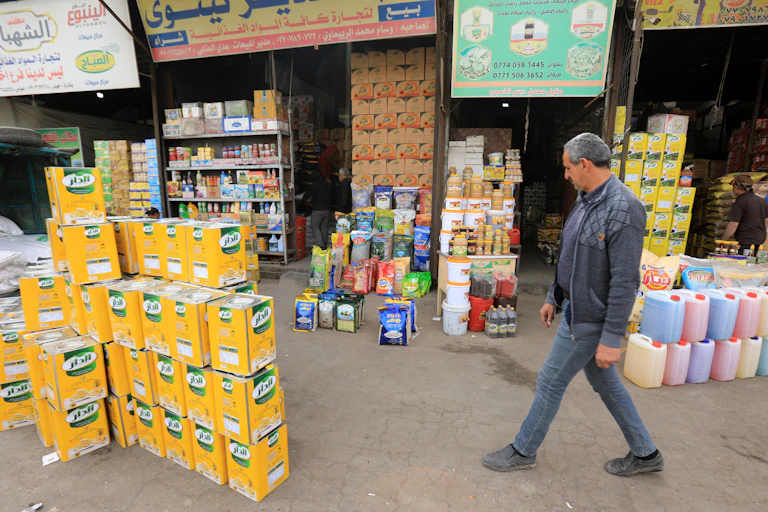 Customer walking through outdoor food market in Baghdad