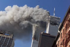 Smoke rises from burning skyscrapers.