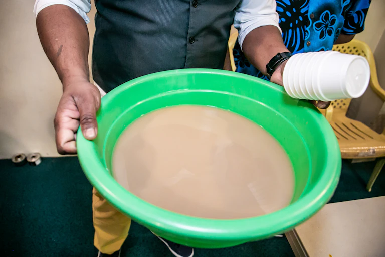 Man holding bowl of kava