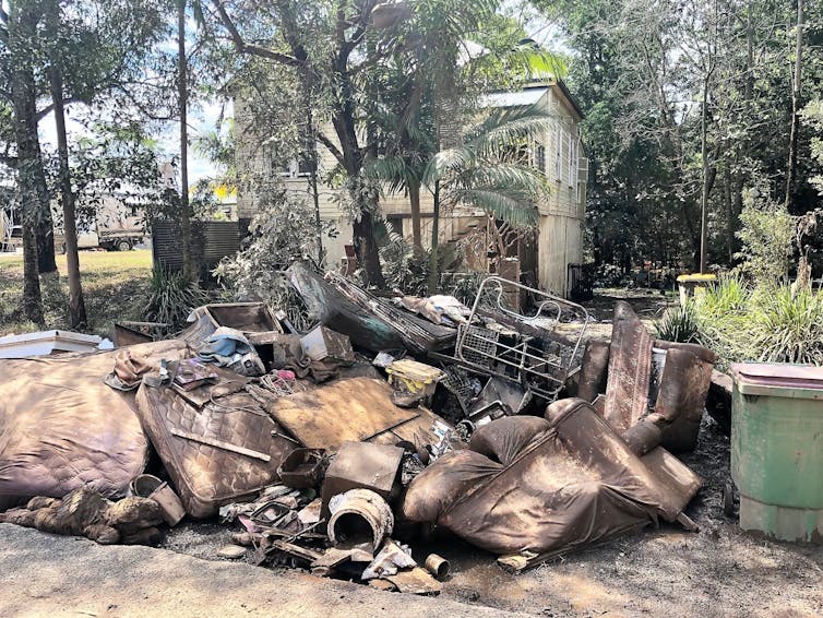 A home with rubbish pile out front