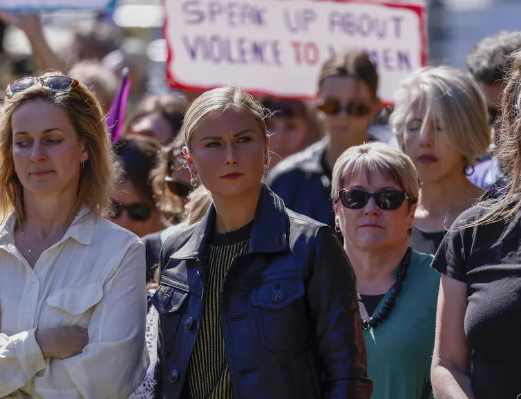 women attend a rally to demand an end to sexual violence