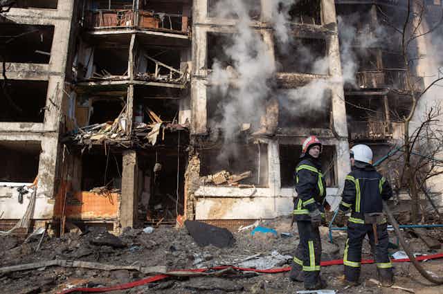 Rescue workers outside a burning block of apartments in Kyiv, March 2022.