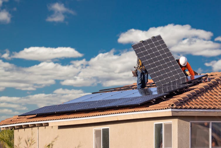 Workers installing solar