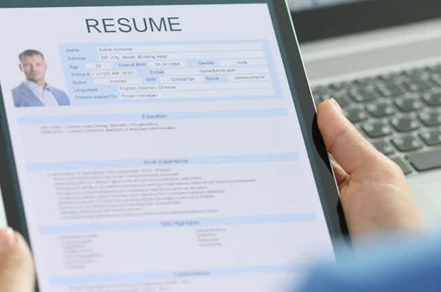 woman looking at an applicant's resume on her tablet