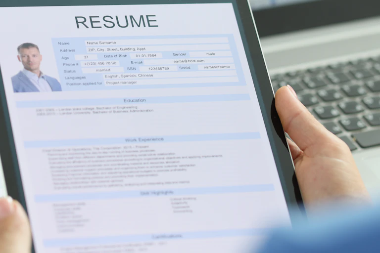woman looking at an applicant's resume on her tablet