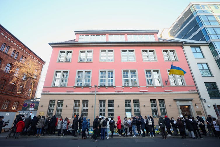 Refugees from Ukraine wait outside the Ukrainian embassy in Berlin, Germany to receive COVID vaccination.