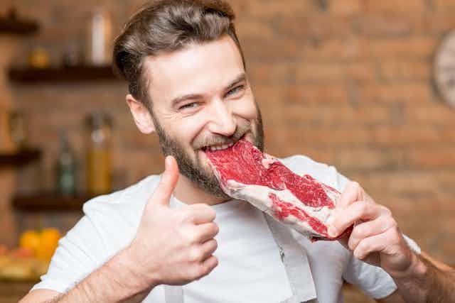 Man eating raw meat
