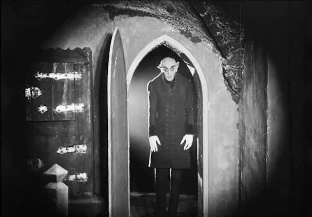 Vampire in doorway.