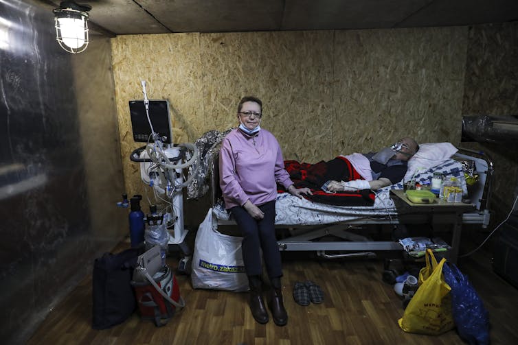 A Ukrainian COVID patient being treated in a hospital basement